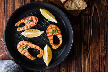 Grilled salmon steaks in cast iron pan.