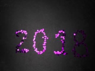 2018 figures on a black background purple sequins, the concept of the new year