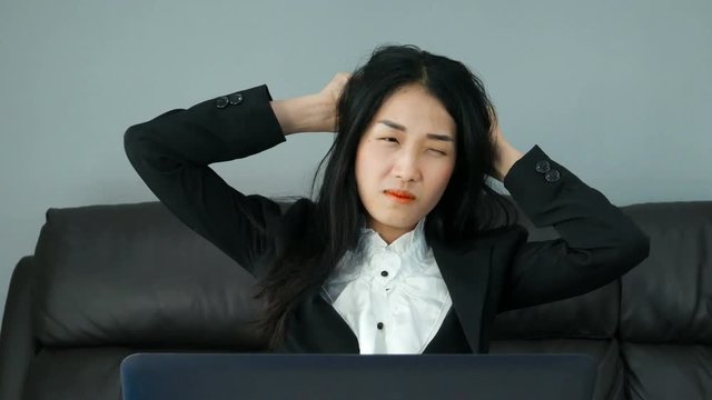 4k of tired and stressed young woman working on a computer