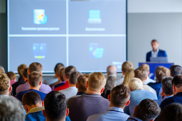 Audience listens to the lecturer at the conference hall