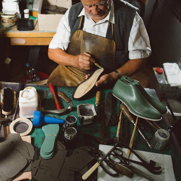 Shoemaker working at his desk