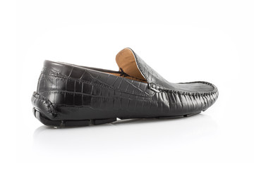 Close up of a black men's moccasins on white background with reflection. Fashion advertising shoes photos.