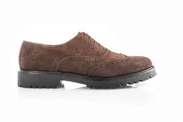 Close up of a brown men's brogues on white background with reflection. Fashion advertising shoes photos.