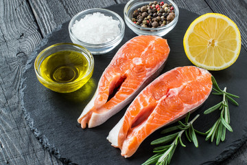 Steaks of raw fresh salmon and ingredients for cooking