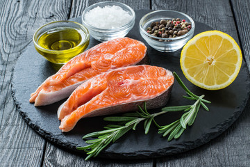 Steaks of raw fresh salmon and ingredients for cooking