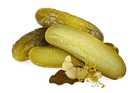 Pickled cucumbers and spices on a white background