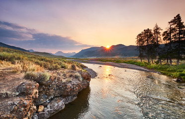 Soda Butte Creek catches sun's first light - Rocky banks on one side and sagebrush flats on the other bank