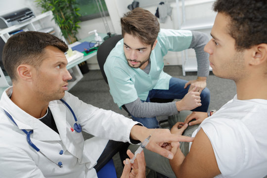 doctor holding a syringe with a liquid