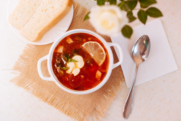 Meat Soup Solyanka, on a wooden table.