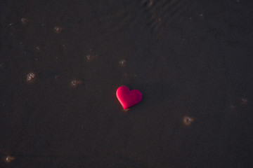 love symbol of heart on the sea beach