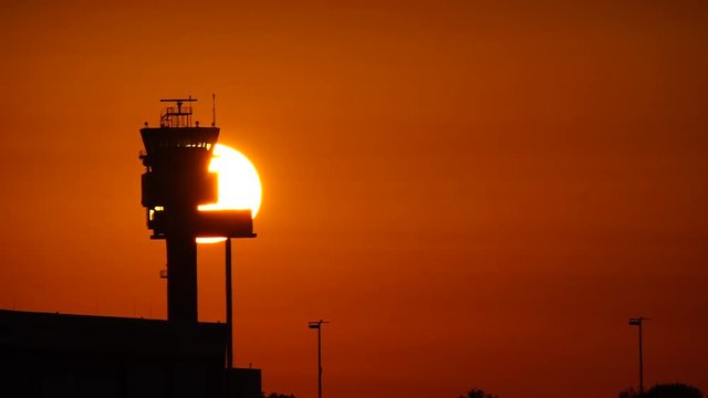 Air traffic control tower in sunset