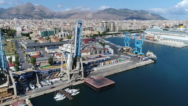 Aerial flying left past harbor cranes located in Port of Palermo in Italian Porto di Palermo port serving Palermo Sicily Italy is one of major ports for passenger traffic in Mediterranean 4k quality
