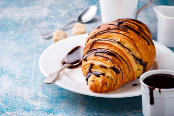   Breakfast Continental  with Fresh  Croissants on a blue Background Coffee  and milk Delicious Baking with  with Chocolate Topping
