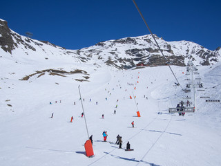  people skiing on a ski slope full of snow