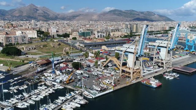 Aerial flying right past harbor cranes located in Port of Palermo in Italian Porto di Palermo port serving Palermo Sicily Italy is one of major ports for passenger traffic in Mediterranean 4k quality