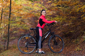 Fototapeta na wymiar Young active sport girl with bicycle outdoor