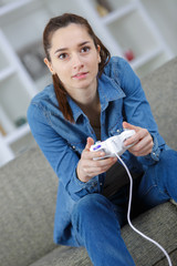 girl playing video game in room © auremar