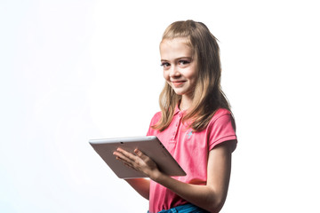 Beautiful little girl with a tablet computer in hands on a white background. Emotions of the child.