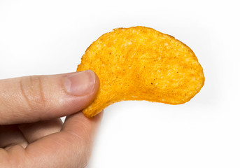 Hand holds potato chips. Isolated on a white background.