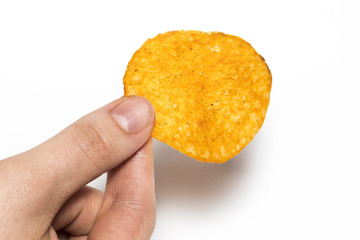 Hand holds potato chips. Isolated on a white background.