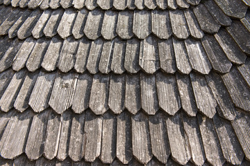 Old wooden roof with dry leaves on it.