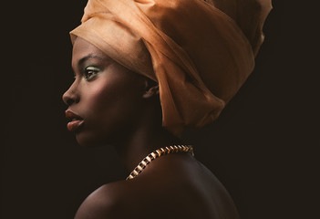 Studio shot of young woman with orange turban