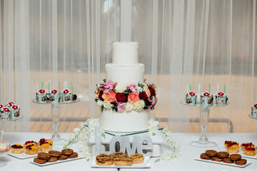 stylish luxury decorated orange candy bar for the celebration of a wedding of happy couple, cathering in the restaurant
