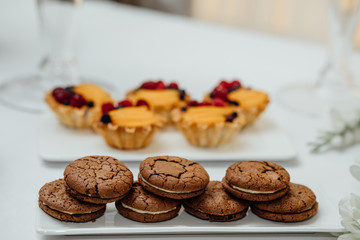 stylish luxury decorated orange candy bar for the celebration of a wedding of happy couple, cathering in the restaurant