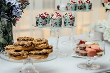 stylish luxury decorated orange candy bar for the celebration of a wedding of happy couple, cathering in the restaurant