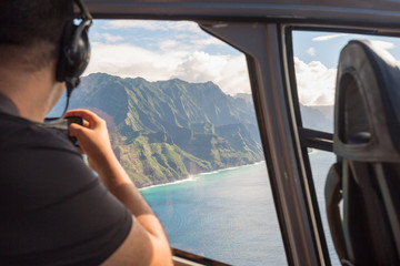 Napali coast from a helicopter with a tourist taking pictures - 178008167