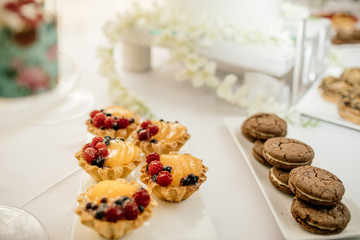 stylish luxury decorated orange candy bar for the celebration of a wedding of happy couple, cathering in the restaurant