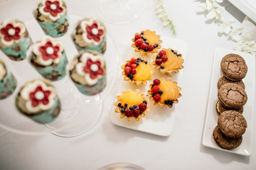 stylish luxury decorated orange candy bar for the celebration of a wedding of happy couple, cathering in the restaurant