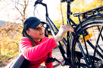 Young active sport girl with bicycle outdoor