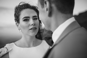 Romantic couple standing together holding hands in the mountains