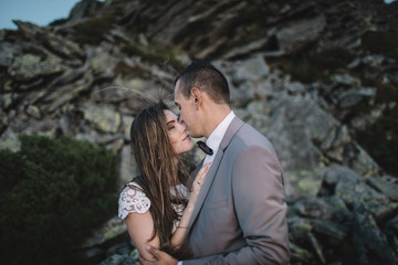 Romantic couple standing together holding hands in the mountains