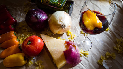 A table with vegetables cheese and wine