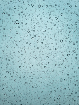 Many droplets on the sunroof of a car