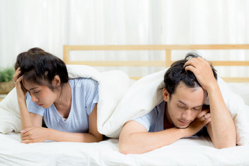 Fototapeta na wymiar Relationship difficulties, conflict and family concept - unhappy couple having problems at bed - lover with conflict and stress on bedroom.