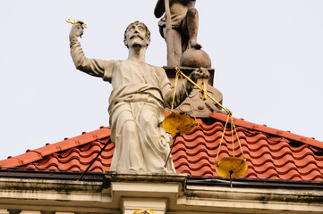 Statue of a man holding gold scales on the Golden Gate in Dluga, Dlugi Targ, Gdansk