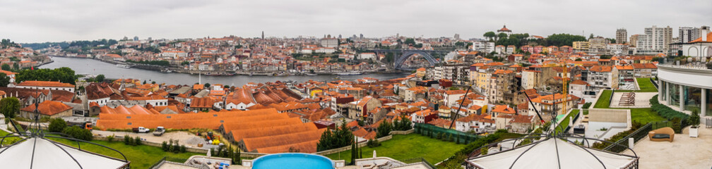 Fototapeta na wymiar Porto, Portugal - July, 2017. Panorama on roof houses Vila Nova de Gaia on Douro river in Porto, Portugal. Porto, Portugal old town on the Douro River.