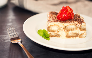 Tiramisu with strawberry on plate