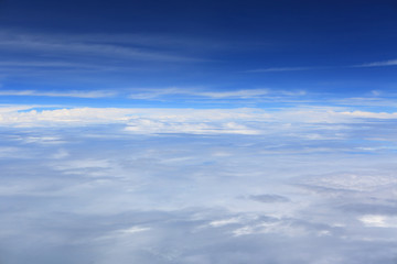 Naklejka na ściany i meble Puffy clouds seen from an airplane.