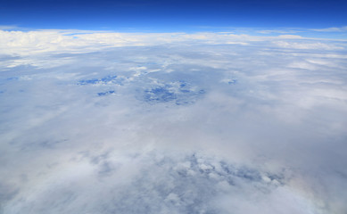 Fototapeta na wymiar Puffy clouds seen from an airplane.
