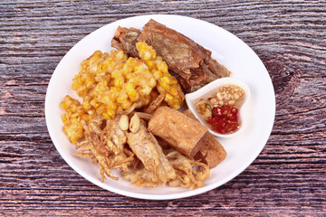 Deep fried dessert of sweet corn,tofu ,taro and  spring roll served with spicy sweet sauce.