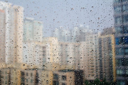rain drops on glass with city background