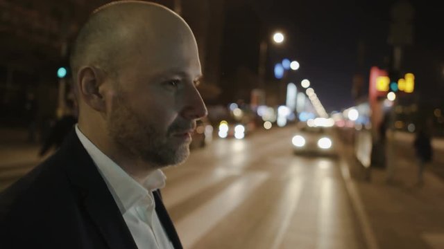 Bald Man Passing a Zebra Crossing and Scratching his Beard