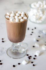 Hot chocolate or cocoa in a glass mug with marshmallows