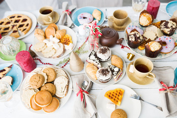 Overview of various pastry and sweet things for guests on holiday table