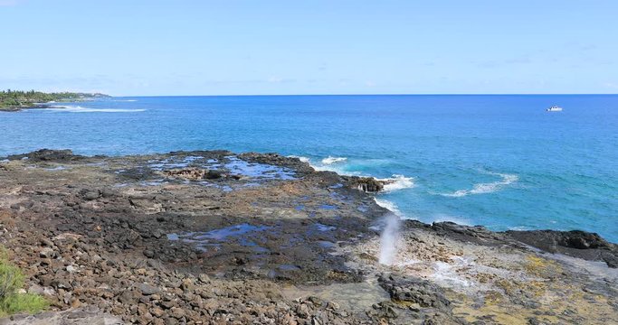 Kauai Hawaii Ocean Park Spouting Horn blowhole. Big Island. Economy is tourism based. Water and tropical beach recreation and fun. Beautiful clear blue ocean sea. 