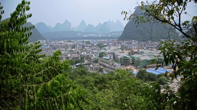 Handheld shot of small famous town or village Yangshuo in Guilin, China. Destination, exploration and tourism concept.